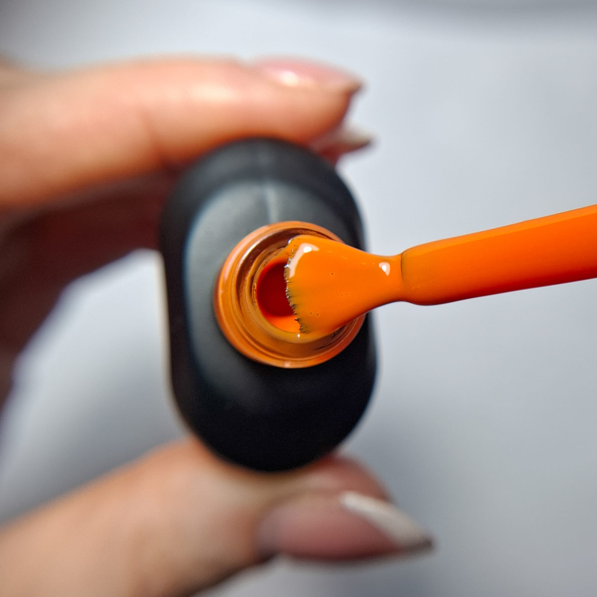 Cuccio Warm Whim gel nail polish brush showing sunset orange highly pigmented colour